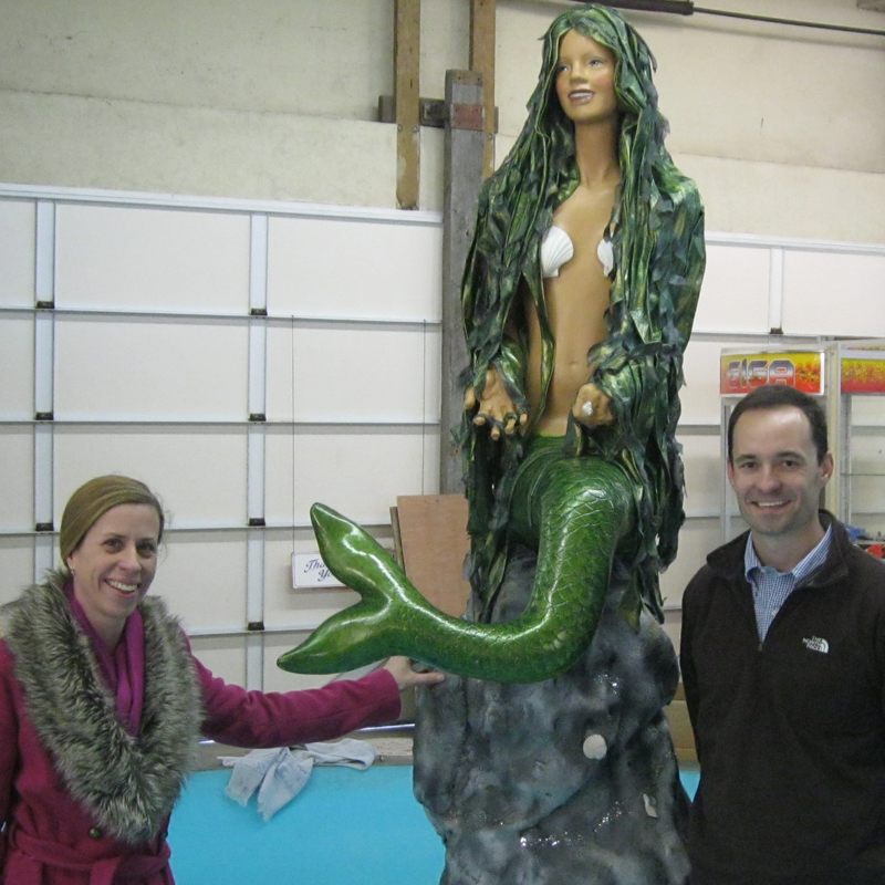Maryland-based artist Maggii Sarfaty, standing along with Funland personnel manager Chris Darr, gave a facelift to the park's mermaid in time for the mermaid's 34th year at Funland's boat ride. Funland had considered replacing the mermaid until Sarfaty volunteered to restore her. BY RYAN MAVITY
